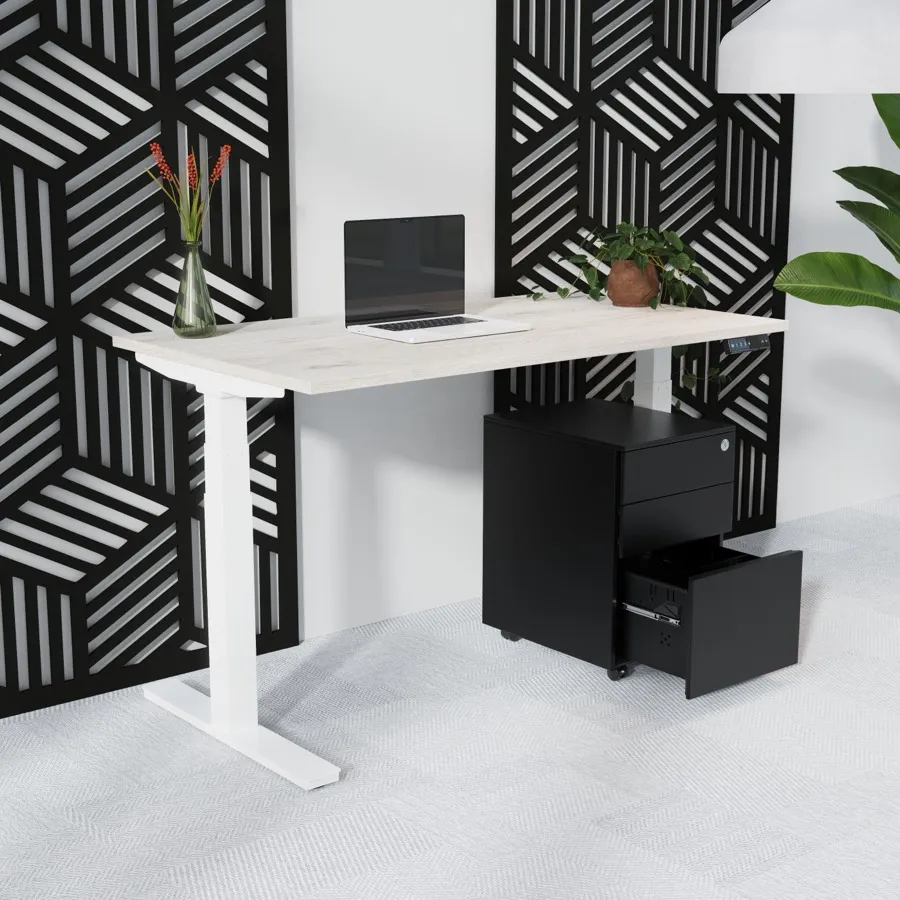 An electric sit-stand desk raised to standing height