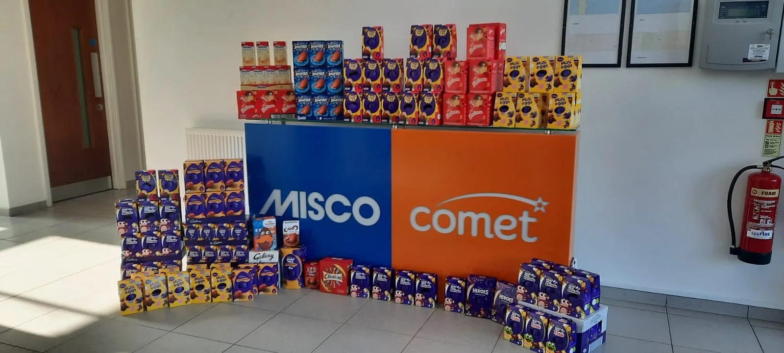 Stacks of donated Easter eggs and boxes lining an office corridor