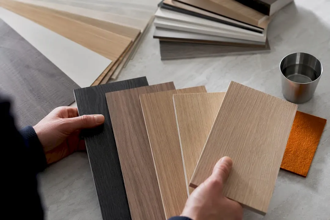 Hands comparing laminate and veneer finish samples