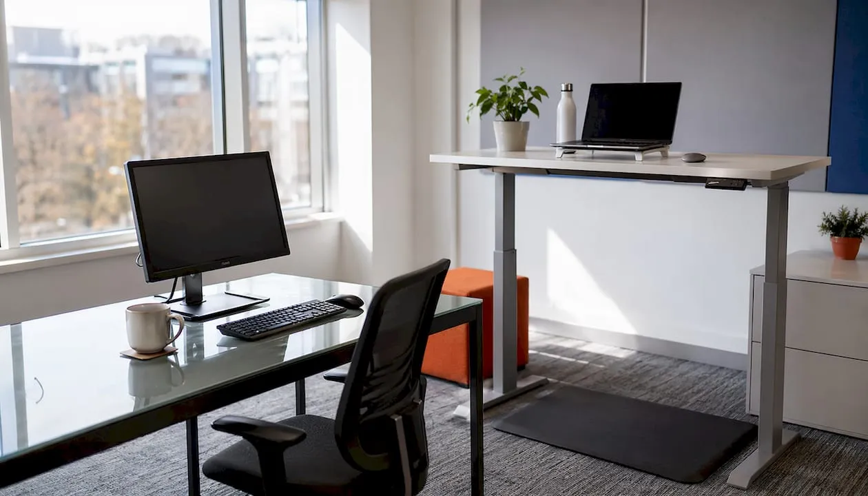 Close-up comparison of traditional and sit-stand desks
