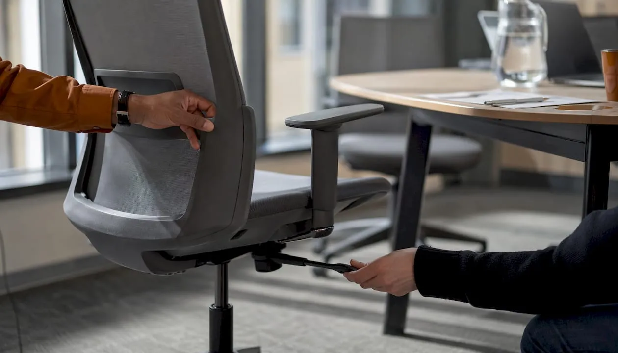 Hands adjusting ergonomic office chair