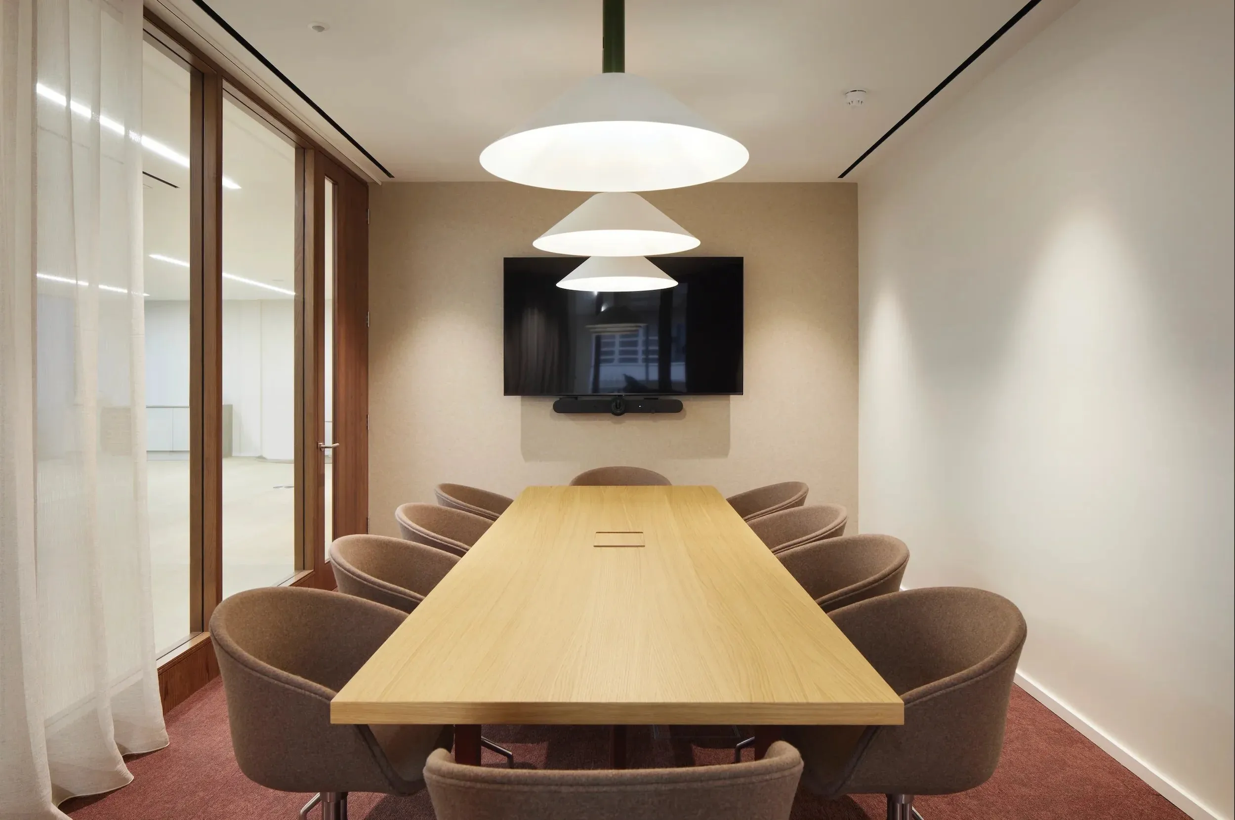 Boardroom with a light timber table and upholstered chairs