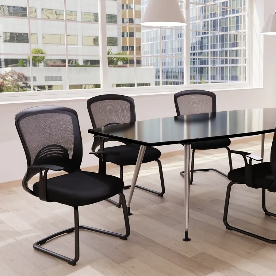Black mesh cantilever boardroom chairs around a glass table