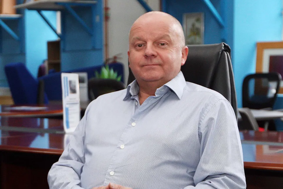 Allister Mulligan, Managing Director, at his desk