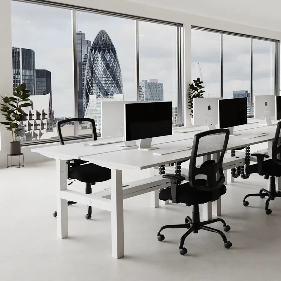 Back-to-back white bench desks in an open-plan office