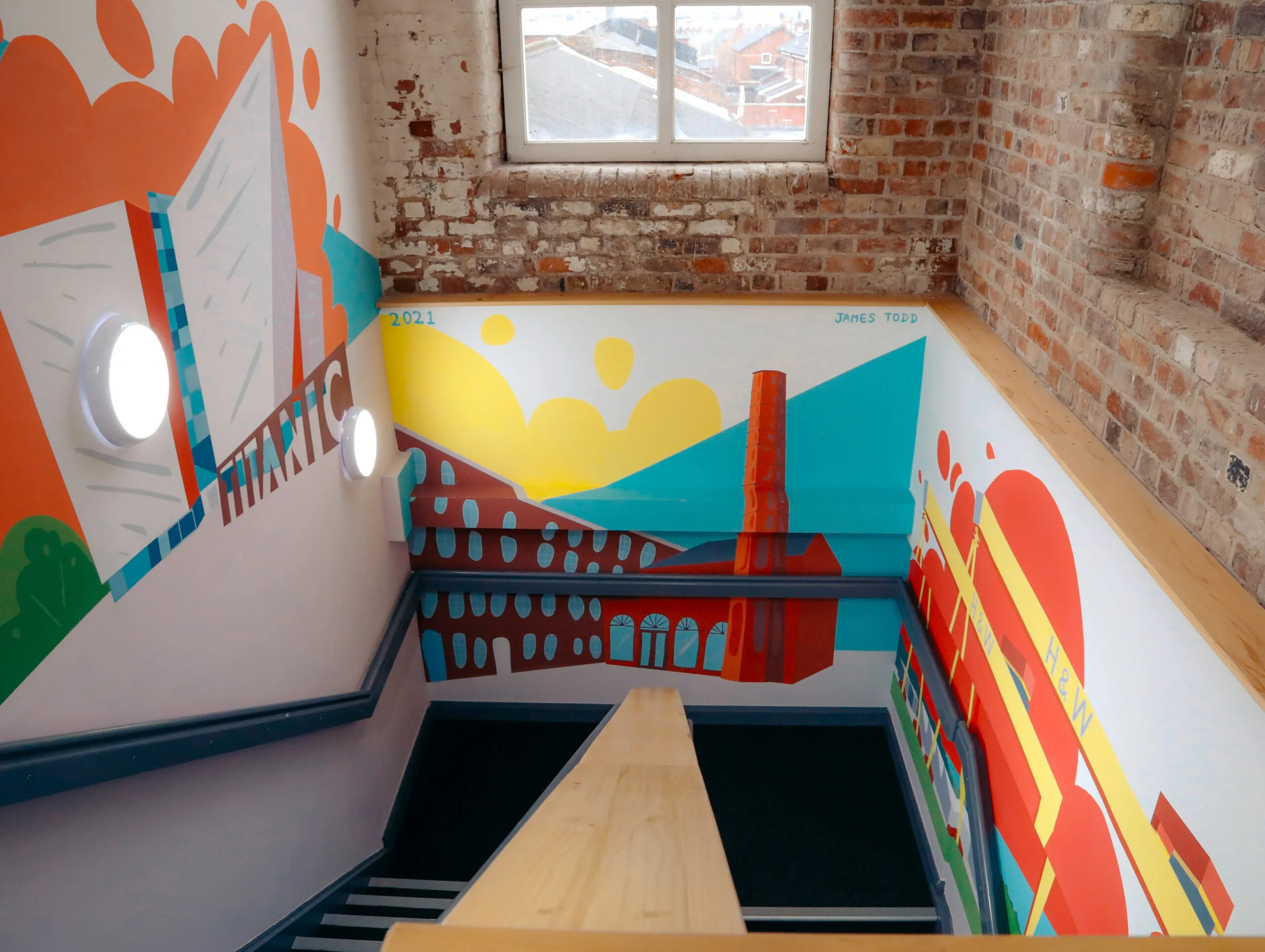 Stairwell mural of Belfast mills and cranes in bright colours