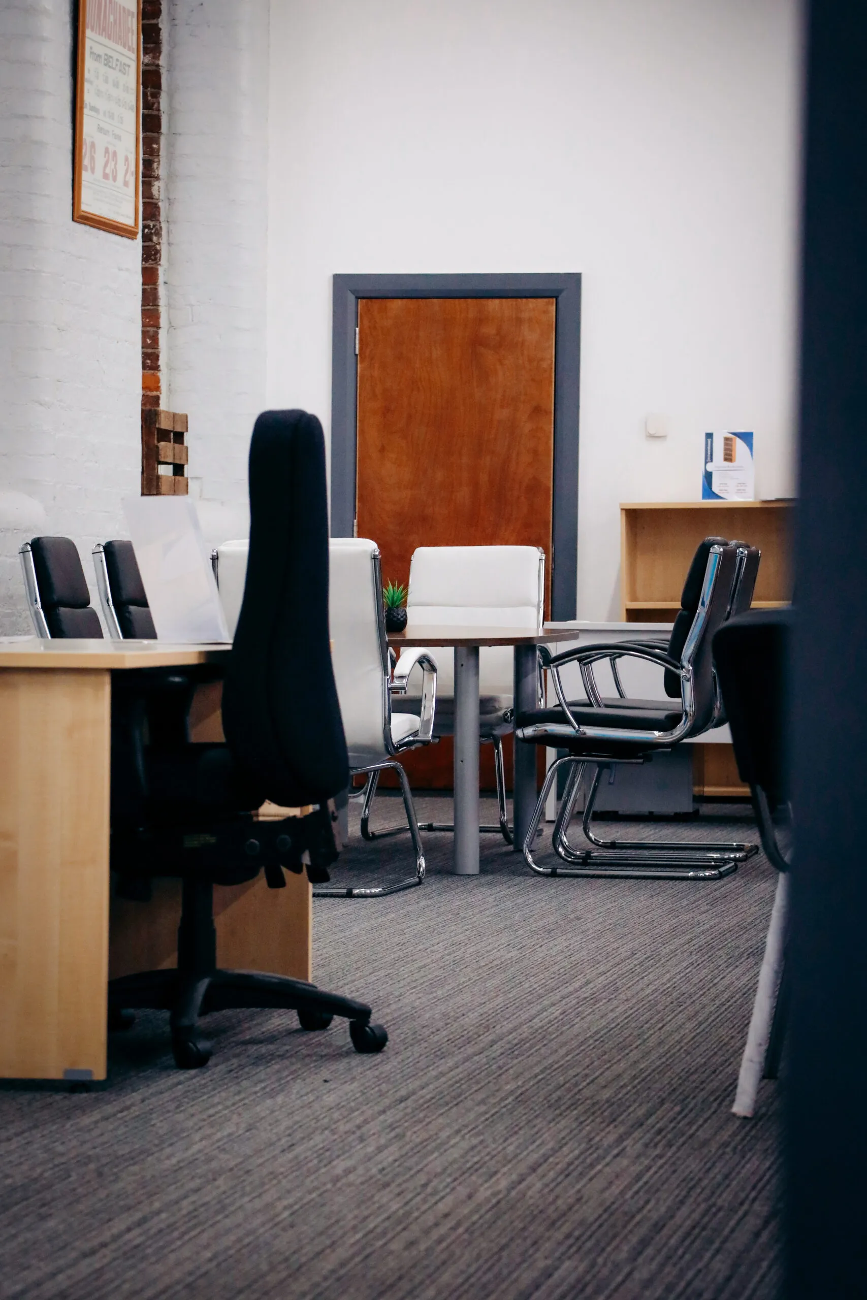 Showroom room with a meeting table and leather chairs
