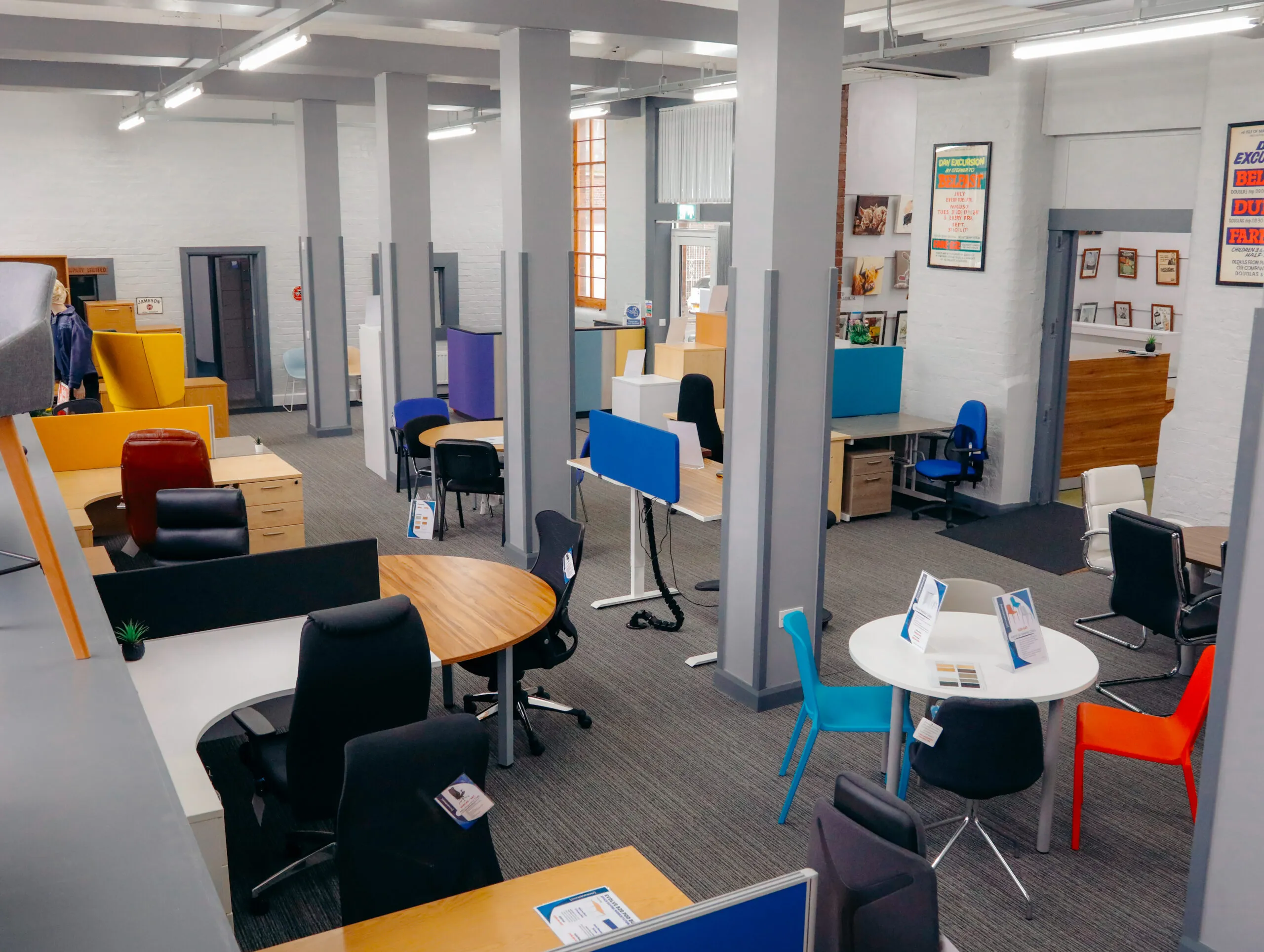 Showroom floor with desks, chairs and cupboards