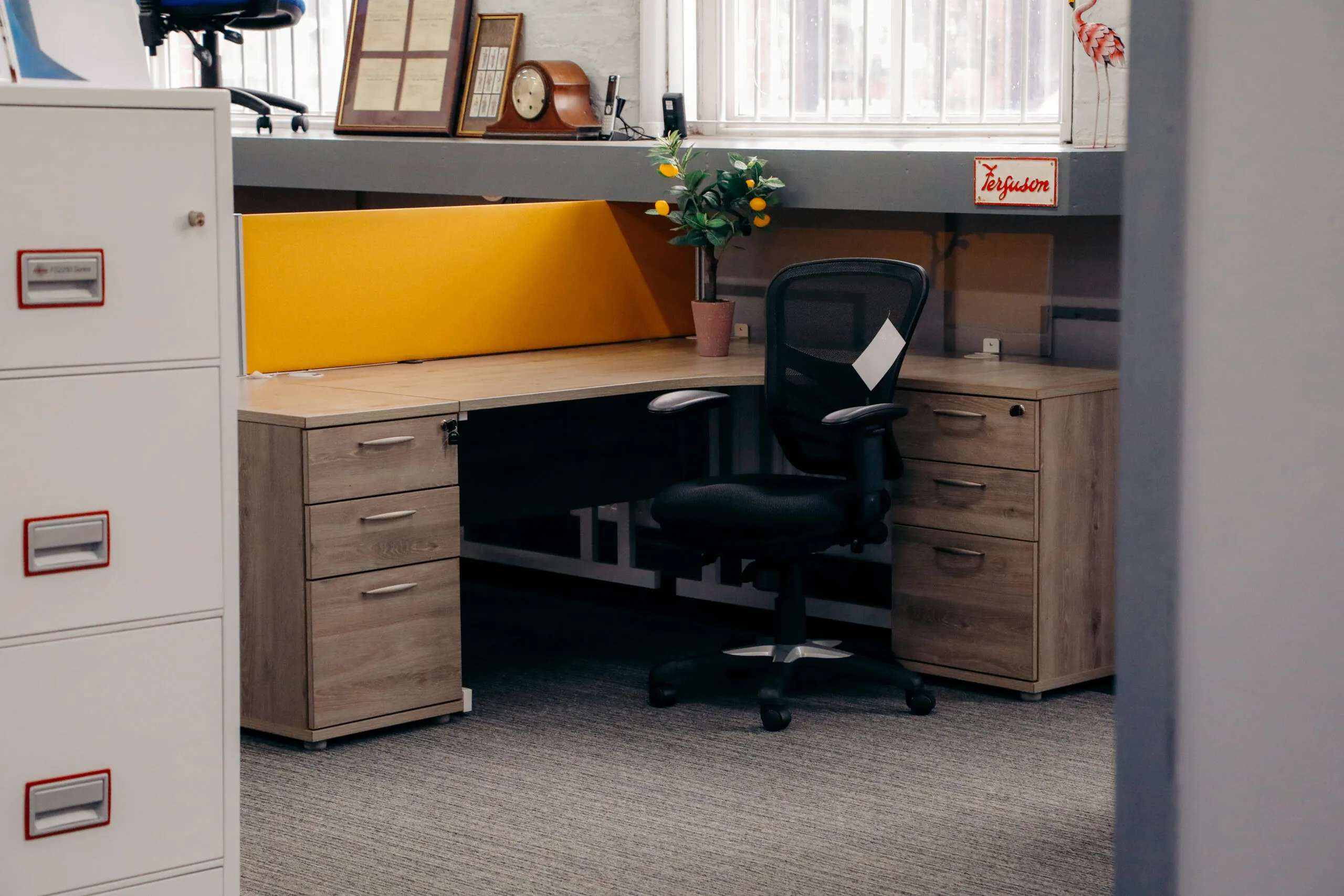 Grey oak desk with a yellow screen, pedestals and a grey filing cabinet
