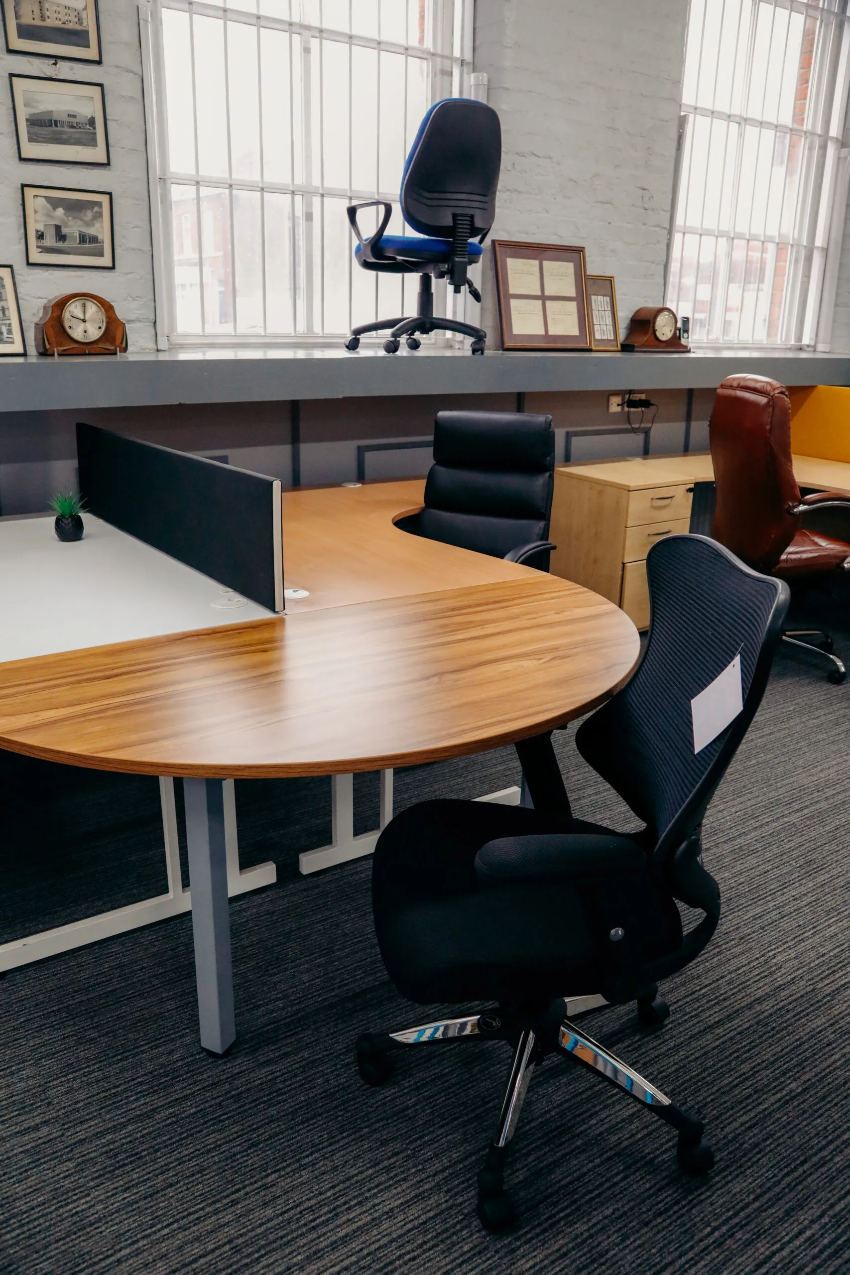 Oak crescent desks with black mesh chairs