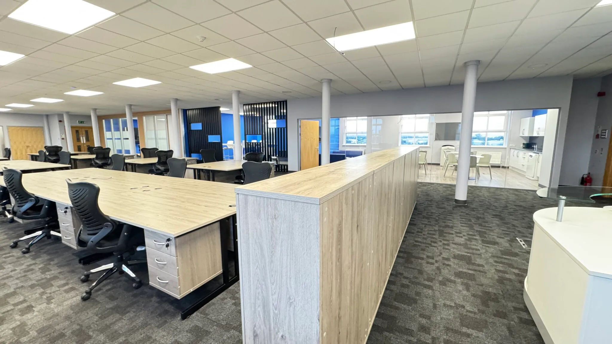 Oak storage wall and bench desks in the finished office