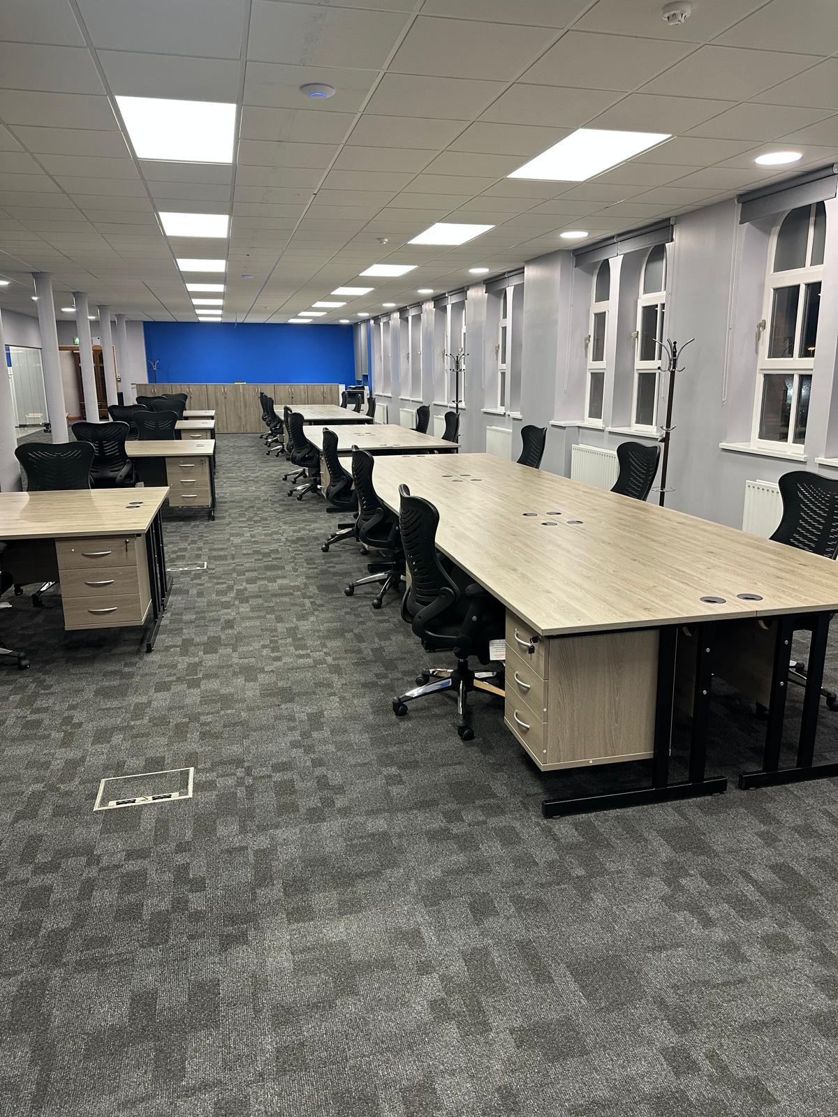 Long rows of bench desks in the finished office