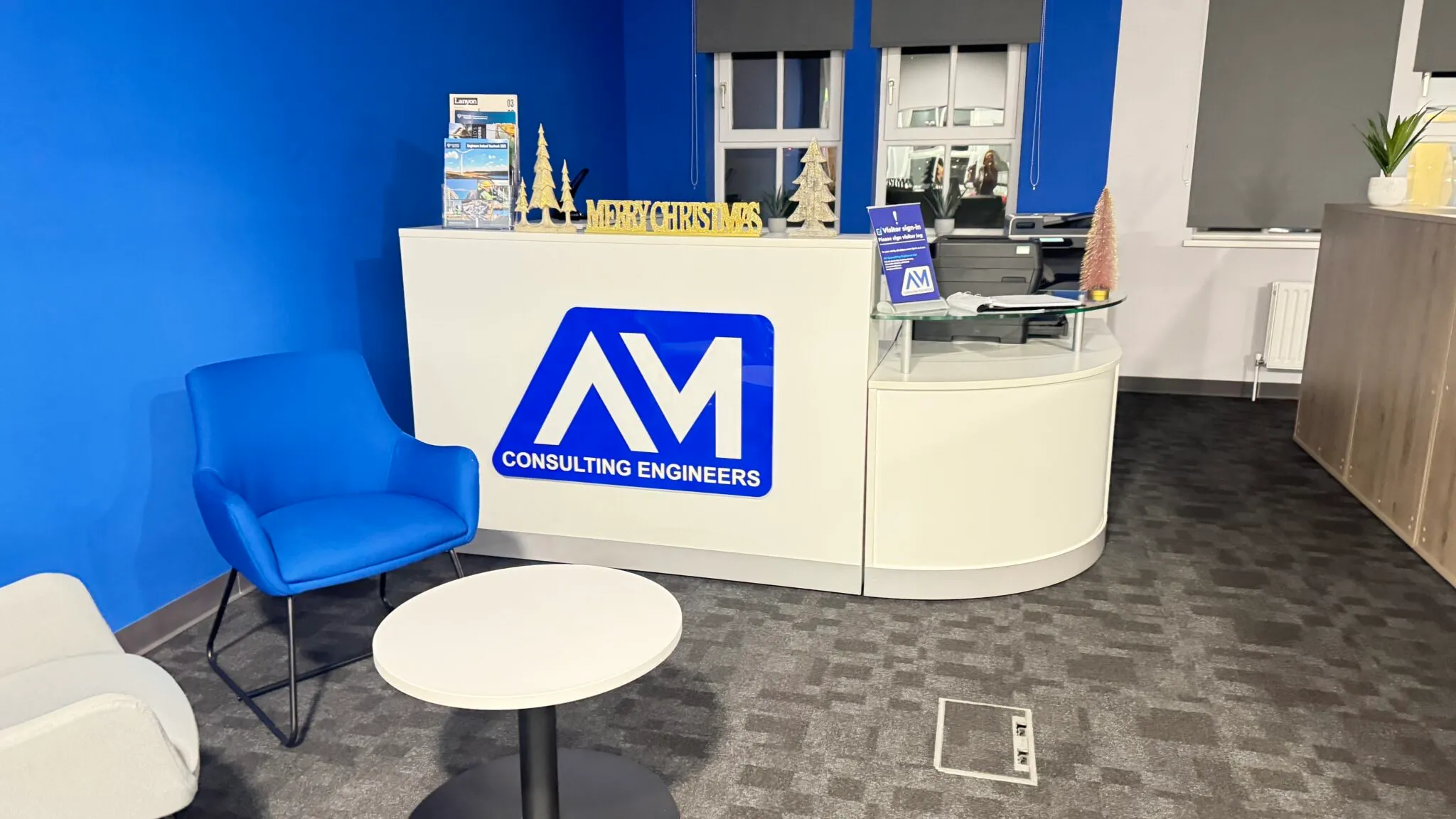 AM Consulting Engineers reception desk with a blue armchair