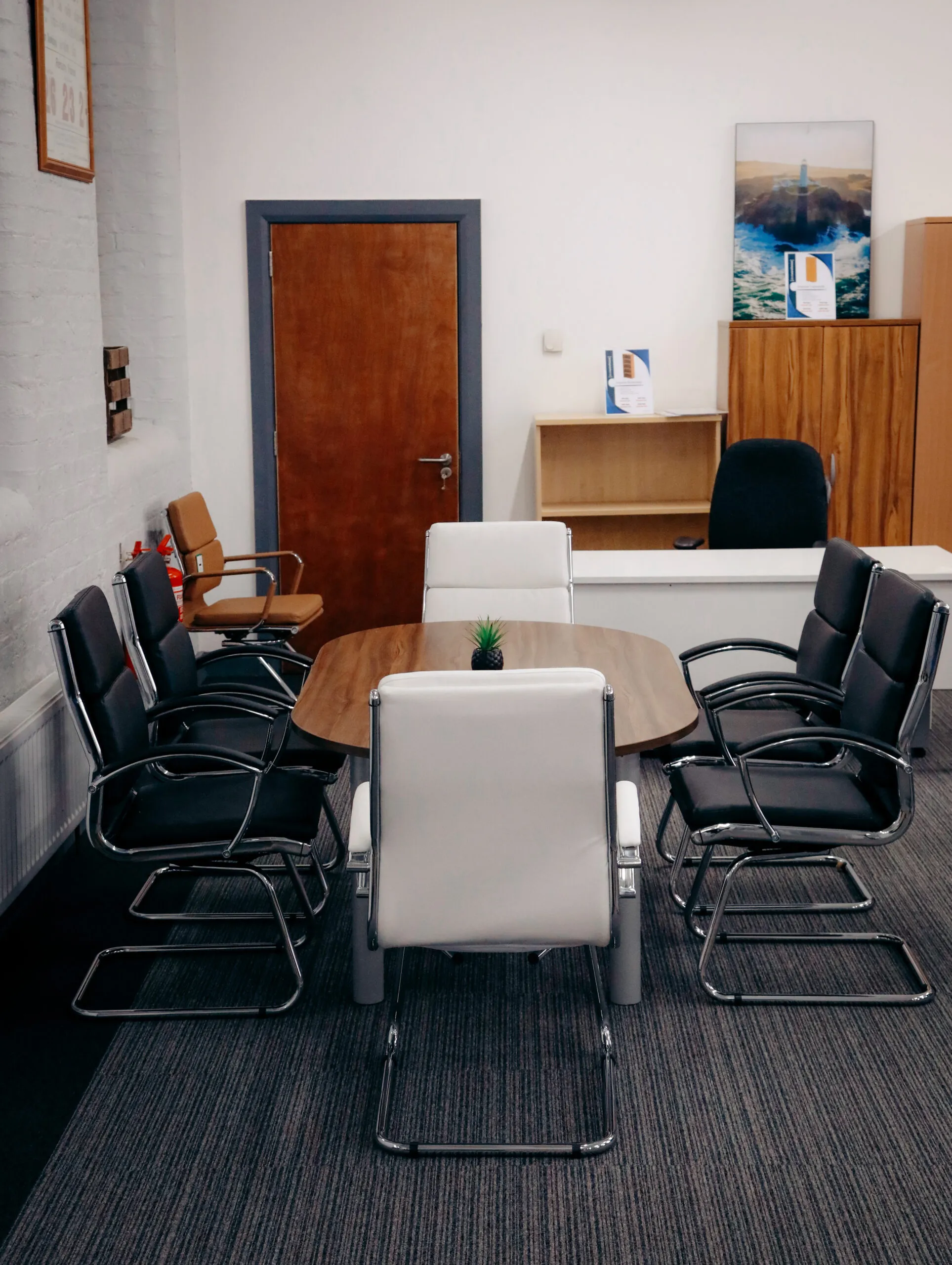 Meeting room with a table and black and white cantilever chairs