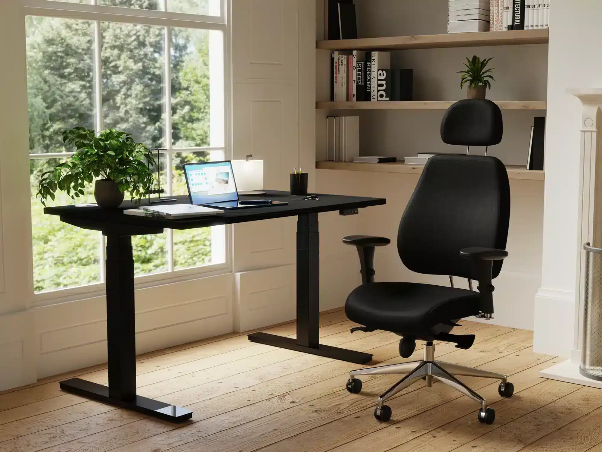 Black posture chair at a black height adjustable desk in a home study
