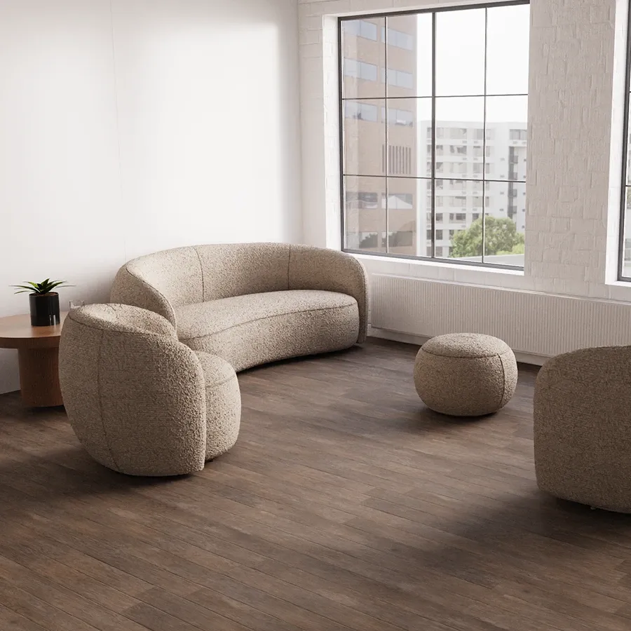 Curved cream sofa and pouffes in a bright lounge
